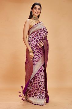 Look your ethnic best on special occasions in this purple Katan silk Banarasi saree. It is adorned with an overall zari minakari work jaal. The saree comes with a matching blouse piece. Disclaimer: The shown stitched blouse on the model is for display purpose only. The saree comes with a matching blouse piece and finished with fall and piko. Banarasi Sari, Silk Banarasi Saree, Indian Clothing Store, Tussar Silk Sarees, Fashion Journals, Katan Silk, Tussar Silk Saree, Traditional Fabric, Zari Work