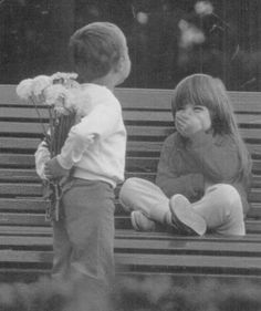 a newspaper article with an image of two children sitting on a bench and one holding flowers