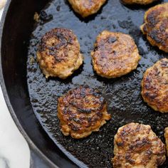 some hamburger patties are cooking in a skillet