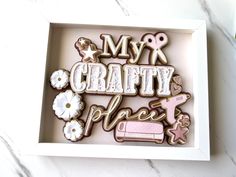 a box with some cookies in it on top of a marble countertop and the words my crafty place