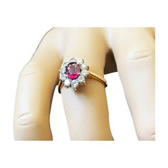 This breathtaking 18K Yellow Gold Ruby & Diamond Ring offers an exquisite 18k gold mounting, including a 2.5mm shank center that showcases an elegantly prong-set medium-grade oval ruby at approximately 1.04 carats. The ruby measures 7.2 x 5.3 x 3.34 mm. The ring is adorned with 10 full-cut, 2.6 mm, 07 point diamonds of JK color and VS clarity. The gold weight of the ring is 2.5 dwt /3.88 grams and is presented in a finger size of 8.5. Marked. Elegant Oval Ruby Ring With Vvs Clarity, Formal Ruby Cluster Ring With Round Shape, Elegant Cluster Ring With Lab-created Ruby, Formal Cluster Ring With Ruby Center Stone, Formal Ruby Cluster Ring With Center Stone, Oval Ruby Cluster Ring Hallmarked, Formal Yellow Gold Ruby Ring With Cubic Zirconia, Formal Oval Ruby Ring With Cubic Zirconia, Oval Ruby Ring With Cubic Zirconia For Formal Occasions