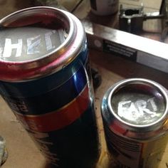 two cans of beer sitting on top of a table