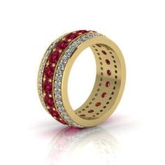 a gold ring with red and white stones on the inside, set in 18k yellow gold