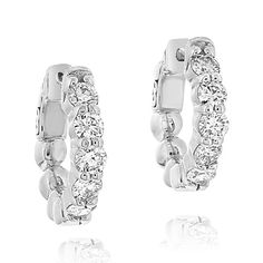 14K white gold diamond huggie hoop earrings from the Reis-Nichols Collection. The earrings feature ten round brilliant cut diamonds weighing approximately 1.00 ctw. Princess Earrings, Diamond Huggies, Jewelry Appraisal, Halo Earrings Studs, Triangle Earrings, Diamond Hoop Earrings, Champagne Diamond, Huggie Hoop Earrings, Gold Drop Earrings