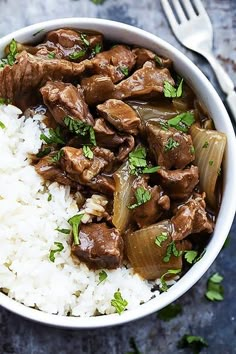 a white bowl filled with rice and beef