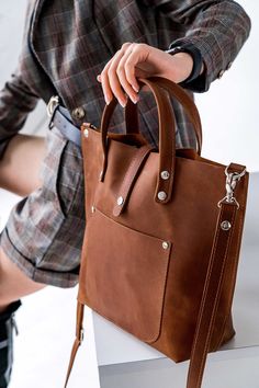 ● Extremely comfortable and very popular bag. It is made of genuine leather cognac color. This bag can be carried in hands and on a shoulder. You can choose an option with and without a shoulder strap. The bag is handmade. Great for daily use. Ideal for work, study. The bag has internal and external pockets, so it is very roomy and functional (for a phone, book, keys, tablet, cosmetic bag, etc.). This model bag can be sewn in different leather colors (olive, cognac, caramel, black, chocolate, gr Leather Shoulder Laptop Bag With Handles, Leather Satchel Laptop Bag With Handles, Leather Laptop Satchel Bag With Handles, Leather Tote Laptop Bag With Handles, Leather Laptop Tote Bag With Handles, Cognac Tote Briefcase For Daily Use, Cognac Tote Briefcase With Leather Handles, Tote Leather Bag, Boho Leather Bags