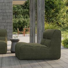 two green chairs sitting on top of a wooden floor next to a table and chair