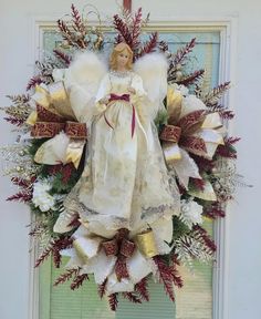 a christmas wreath with an angel on it