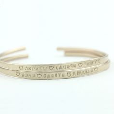 "Personalized solid gold cuff bracelet. Available in 14k or 18k yellow gold, rose gold or white gold. Personalized with a hand stamped engraved inscription or left bank. The inscription is not darkened in unless specifically requested. I hand hammer each one so there is some variation to each one and there is a sight textured on the edges which gives them an organic and rustic look to them. Wear one at a time or stack them all up. To figure out your sizing measure the circumference of your wrist Modern Engraved Bangle For Anniversary, Modern Engraved Yellow Gold Name Bracelet, Elegant Hand Stamped 14k Gold Jewelry, Luxury 14k Stamped Bangle Gift, Elegant 14k Gold Hand Stamped Jewelry, Elegant Yellow Gold Jewelry With Engraved Text, Elegant Gold Name Bracelet With Engraved Text, 14k Gold Jewelry With Engraved Text, Elegant Engraved Cuff Bracelet As Personalized Gift