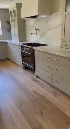 a kitchen with an oven, stove and cabinets on the counter tops is shown in this image