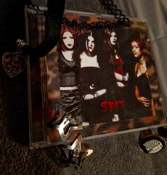 an image of a group of women on the cover of a cd with chains attached to it