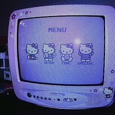 an old tv with hello kitty on it's screen and four little kittens drawn on the screen