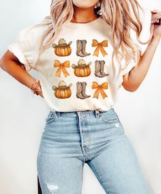 Enjoy the fall season with our Cowboy Halloween Shirt! This women's fall shirt features a charming autumn cowgirl design, perfect for celebrating Halloween, Thanksgiving, and all your fall festivities. Made from high-quality Comfort Colors fabric, this fall graphic tee ensures comfort and style. The Western howdy pumpkin top adds a playful touch to your seasonal wardrobe, making it a versatile piece for any occasion. Whether you're heading to a pumpkin patch or a festive gathering, this autumn cowgirl shirt is a must-have. Features: Soft, high-quality Comfort Colors fabric Charming cowboy Halloween and howdy pumpkin design Perfect for fall, Halloween, and Thanksgiving celebrations Comfortable and stylish fit Great addition to your seasonal wardrobe 🎨 Colors: Available in a range of autumn White Western Shirt For Fall, Western Style White Shirt For Fall, Trendy Fall Short Sleeve Shirt, Trendy Short Sleeve Fall Shirt, White Western Style T-shirt For Fall, Cute Fall Crew Neck Shirt, Casual Fall T-shirt With Cow Print, Cute Crew Neck Fall Shirt, Casual Cow Print T-shirt For Fall