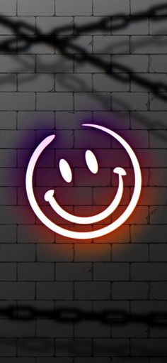 a brick wall with a neon smile sign on it's side and wires in the background