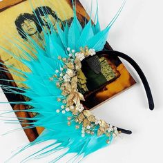 Feather Fascinator 'Lakita Bijoux' designed by Divalicious in Aqua Blue. Divalicious Feather Fascinator 'Lakita Bijoux' is a stunning piece handcrafted with quality feathers and vintage style jewels. Description: Aqua blue spiked feathers with a gold wired pearl, crystal & diamante jewelled headpiece designed on a black satin Alice headband. The headband is approximately 1.3cm wide and is easy and comfortable to wear. Wear her to the races, weddings, festivals and swanky soirées. Style 'Lakita B Jewelled Headpiece, Alice Headband, Feather Crown, Orange Sherbet, Aqua Blue Color, Feather Headpiece, Melbourne Cup, Pearl Jewels, Satin Noir