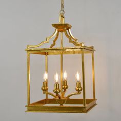 a chandelier with four lights hanging from the ceiling