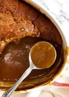 a bowl filled with pudding next to a spoon