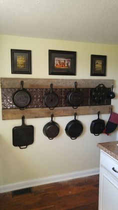 a kitchen with pots and pans hanging on the wall