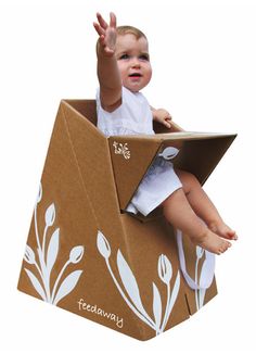 a small child sitting in a cardboard box