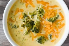 a white bowl filled with broccoli cheese soup