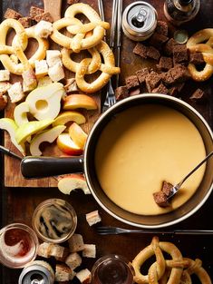 an assortment of snacks including pretzels, apple cider and caramel sauce