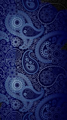 an abstract blue background with swirls and dots in the shape of paisley patterns on black paper