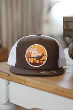 Tall Crown Brown/White Yupoong snapback Vibrant embroidery patch White Retro Hat With Logo Patch, Retro White Hat With Logo Patch, Outdoor Snapback Hat With Embroidered Patch, White Trucker Snapback Hat With Patches, Retro Snapback Hat With Embroidered Patch, Brown Trucker Hat With Embroidered Patch, Brown Flat Bill Trucker Hat With Embroidered Patch, Brown Flat Bill Hat With Embroidered Patch, Retro Embroidered Snapback Baseball Cap