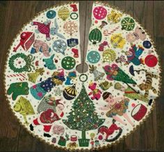 a christmas tree skirt made out of fabric and sequins on a wooden floor