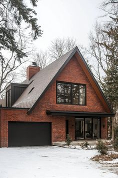 a large brick house with black garage doors and windows