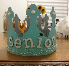 a blue crown sitting on top of a wooden table