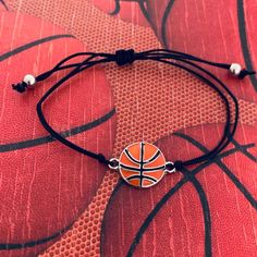 🏀BASKETBALL BRACELET - Basketball Charm on Adjustable Bracelet 🏀ADJUSTABLE - Basketball bracelet is adjustable. Easily Adjusts to Fit your Wrist 5" to 8" *will fit most wrists sizes small to large 🏀BASKETBALL GIFT - Looking for an inexpensive Basketball gift ? Got a birthday, holiday, or other special occasion coming up for the Basketball player in your life? This high quality yet inexpensive bracelet makes a great gift, whether for a friend, daughter, girlfriend, or teammate. 🏀DESIGNED & SO Basketball Bracelet, Adjustable String Bracelet, Basketball Jewelry, Basketball Accessories, Bola Basket, I Love Basketball, Preppy Jewelry, Basketball Gifts, Infinity Jewelry