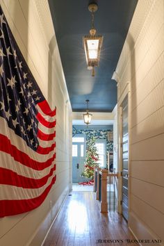 an american flag hanging on the wall in a hallway