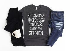 a t - shirt that says, my favorite hockey player cares me grandma and two pairs of jeans