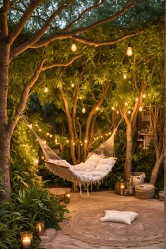 a hammock in the middle of a garden with lights strung from trees and hanging lanterns