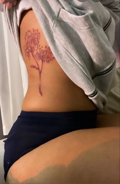 a woman with a tattoo on her stomach