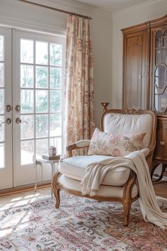 a living room filled with furniture next to a window covered in curtained drapes