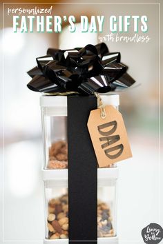 a father's day gift is displayed in clear containers with black ribbon and tag