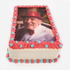 a cake with a photo of an older man on it and red, white, and blue frosting