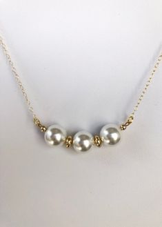 Pretty medium sized white pearls are separated by 2 small gold plated disks hangs from a delicate gold filled chain and has a lobster clasp. Simple Gold Jewelry With Pearl Pendant, Dainty Gold Pearl Necklace With Gold Beads, White Pearl Chain Necklace In 14k Gold Filled, Gold Pearl Charm Necklace With Delicate Chain, Everyday Gold Pearl Charm Necklaces, White Pearl Necklace With Delicate Chain For Party, Simple White Pearl Chain Jewelry, Elegant 14k Gold-filled Pearl Chain Charm Necklace, White Pearl Chain Necklace In 14k Gold