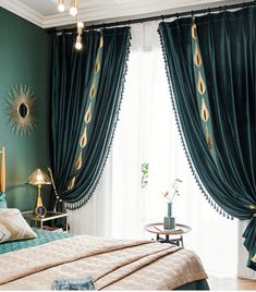 a bedroom decorated in green and gold with peacock feathers on the drapes, curtains, and bedding