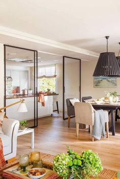 a living room filled with furniture and a dining table