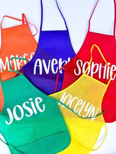 six personalized aprons with the names of different colors and styles are shown in this image