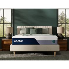 the nectar mattress is on display in front of a window with two nightstands and lamps