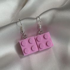 These pink brick earrings are the perfect nostalgic gift for those who grew up with building blocks! These quirky earrings are the perfect fashionable jewellery and a great gift for yourself, teens or kids. - Handmade by me  - Hypoallergenic gold plated 304 stainless steel hooks - All earrings come with a rubber back. - Your purchase will come in a card holder, bag, and a bag of sweets 🍬  Care info:  Please take care of your handmade earrings. Do not sleep in them, come into contact with water Artsy Pink Earrings For Gifts, Pink Rectangular Earrings As Gift, Colorful Retro Earrings For Gift, Pink Rectangular Earrings For Gift, Pink Rectangular Earrings For Gifts, Rectangular Pink Earrings For Gifts, Pink Square Jewelry Gift, Pink Square Jewelry For Gifts, Handmade Retro Pink Earrings