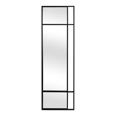 a tall mirror sitting on top of a white wall next to a black framed door