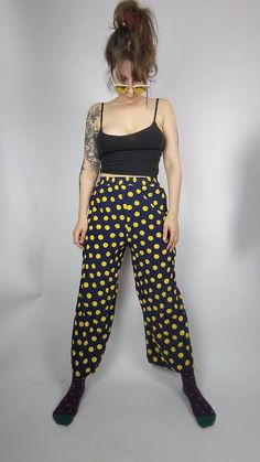 You are looking for a comfy but also stylish summer pants? These wonderful darkblue midi pants are printed with big yellow dots that bring the sunshine right to you.  DETAILS: no size label, seems like S, check measurements below navy blue with yellow polkadots wide leg style comfy fit elastic waistband light summer fabric Vintage condition: VERY GOOD there is a tiny irritation in the fabric at one side and small hole above it at the waistband  length: 95cm waist width: 30 - 45cm (stretchy) wais Retro Wide Leg Pants For Loungewear, Spring Polka Dot Cotton Pants, Retro Loungewear Pants With Elastic Waistband, Retro Bottoms With Elastic Waistband For Loungewear, Retro Loungewear Bottoms With Elastic Waistband, Retro Relaxed Fit Bottoms With Elastic Waistband, Retro Wide Leg Loungewear Bottoms, Retro Relaxed Fit Loungewear Bottoms, Retro Relaxed Loungewear Bottoms