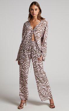 Go wild with the Aegir Pants! Featuring mid-high rise elastic waist with drawstrings,  straight legs, relaxed fit and a pink zebra print all over. They're easy, breezy and perfect casual days out, parties and beyond.Style it with the Aegir Blouse - Tie Front Drop Sleeve Blouse in Wild Zebra and chunky sandals for a relaxed vacay look. Or pop on heeled sandals and a shoulder bag for a party look!Product Details   Pull on style, no fasteningElasticated waistband with adjustable drawstringsMid-high Summer Zebra Print Wide Leg Bottoms, Spring Wide Leg Zebra Print Pants, Casual Wide Leg Bottoms With Zebra Print, Spring Wide Leg Zebra Print Bottoms, Casual Zebra Print Bottoms For Summer, Casual Zebra Print Summer Bottoms, Casual Tiger Print Bottoms For Summer, Casual Tiger Print Summer Bottoms, Casual Summer Bottoms With Tiger Print