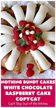 a cake with white chocolate and raspberries on top is featured in this post