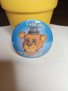 a yellow flower pot with a button on it that says faze air enter animent