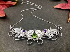 I've handmade this beautiful rustic themed Woodland Leaves Necklace keepsake, perfect for a Woodland wedding theme, or any event, casual or high end, you desire! I've designed this in sterling silver with 3 gemstones. The top two are 4mm round faceted natural amethysts complete with a center 8mm faceted rainbow Topaz. The leaf work design is approximately 3.5 inches wide with a 13 inch chain soldered to either end for an approximate length of 16 or so inches. If you prefer it shorter or longer, Artisan Wire Wrapped Jewelry For Wedding, Artisan Wire Wrapped Wedding Jewelry, Artisan Wedding Necklaces With Unique Variations, Whimsical Handmade Necklaces For Weddings, Handmade Wedding Pendant Necklace, Hand Forged Pendant Necklaces For Wedding, Nature-inspired Sterling Silver Wedding Necklaces, Nature-inspired Sterling Silver Necklace For Weddings, Whimsical Sterling Silver Wedding Jewelry